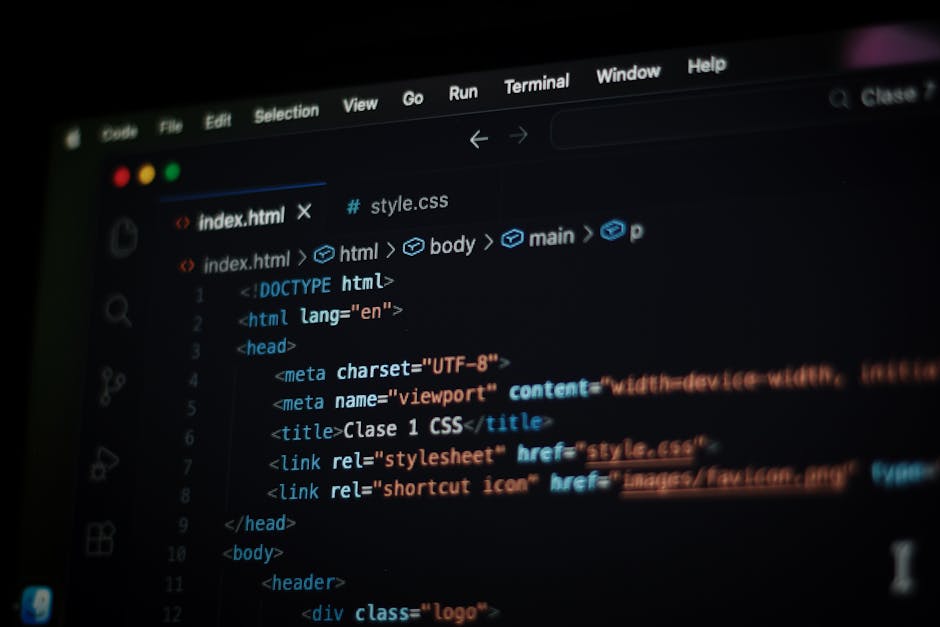 A close-up view of a computer screen displaying lines of colorful code in green, white, purple, and orange text on a dark background. The screen is slightly angled, with the code suggesting software d